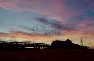 Low level silhouette image of Bournemouth Pier at sunrise